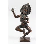 A 19TH CENTURY NEPALESE BRONZE FIGURE OF KALI, the dancing female deity holding chopper and skull