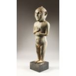 A LARGE LEAD FIGURE OF A BOY, IN PRE-ISLAMIC SOUTH ARABIAN STYLE, nude except for a cap on his head,