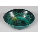 A CIRCA 16TH CENTURY PERSIAN TURQUOISE GLAZED BOWL, 22cm diameter.