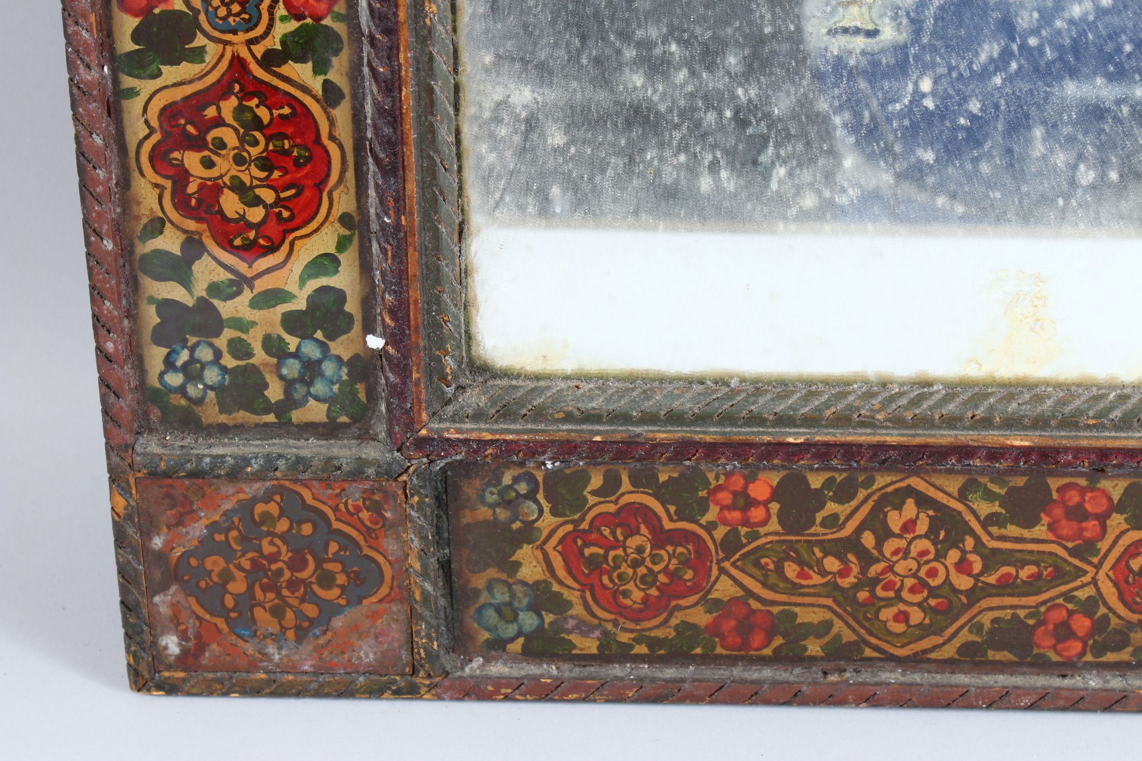 A 19TH CENTURY PERSIAN QAJAR HAND PAINTED WOODEN MIRROR, with shaped top, the mirrored panel - Image 4 of 6