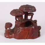 A CHINESE CARVED WOOD BRUSH WASHER of mushrooms. 10cm high.