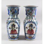 A PAIR OF EARLY 20TH CENTURY PERSIAN QAJAR HAND PAINTED POTTERY VASES, painted with reverse panels