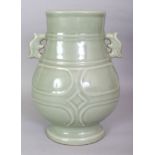 A CHINESE CELADON PORCELAIN RIBBED HU VASE, the base with a Qianlong seal mark, 8.2in wide including