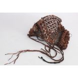 AN UNUSUAL KNOTTED LEATHER HEADDRESS, PROBABLY NORTH AFRICA, EARLY 20TH CENTURY, decorated with