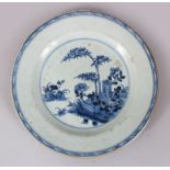 A CHINESE 18TH CENTURY BLUE AND WHITE PLATE, trees and fence pattern, 22cm in diameter.