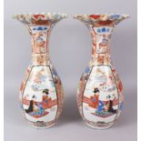 A PAIR OF JAPANESE VASES with fluted tops, the bodies painted with panels of birds, flowers and