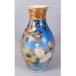 A GOOD JAPANESE SATSUMA BLUE GROUND VASE, painted with storks, other birds and a pond. 41cm high.