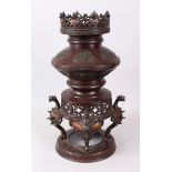 A JAPANESE BRONZE KORO, with pierced top, panels of birds, on griffin supports and circular base.