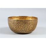 A 20TH CENTURY THAI SILVER GILT CIRCULAR BOWL, with Chinese embossed marks, 13.5cm diameter.