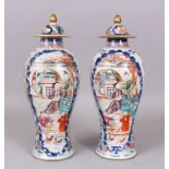 A GOOD PAIR OF 18TH CENTURY CHINESE FAMILLE ROSE VASES AND COVERS, decorated with reverse panels