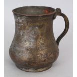 AN OTTOMAN TINNED COPPER TANKARD, CIRCA 1800, WITH SCROLLING HANDLE AND ENGRAVED BOTEH, foliate