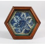 A RARE 15TH CENTURY MAMLUK BLUE AND WHITE POTTERY TILE, PROBABLY SYRIA, 18cm x 16cm in a wooden