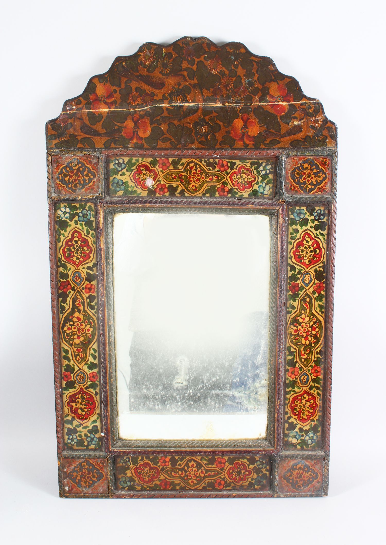 A 19TH CENTURY PERSIAN QAJAR HAND PAINTED WOODEN MIRROR, with shaped top, the mirrored panel