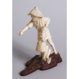 A GOOD QUALITY JAPANESE IVORY OKIMONO ON A WOODEN STAND, an old Japanese man stood with his hand
