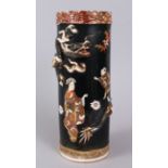 A JAPANESE BLACK GROUND ROULEAU VASE, painted with figures, with dragons in relief. 31cm high.