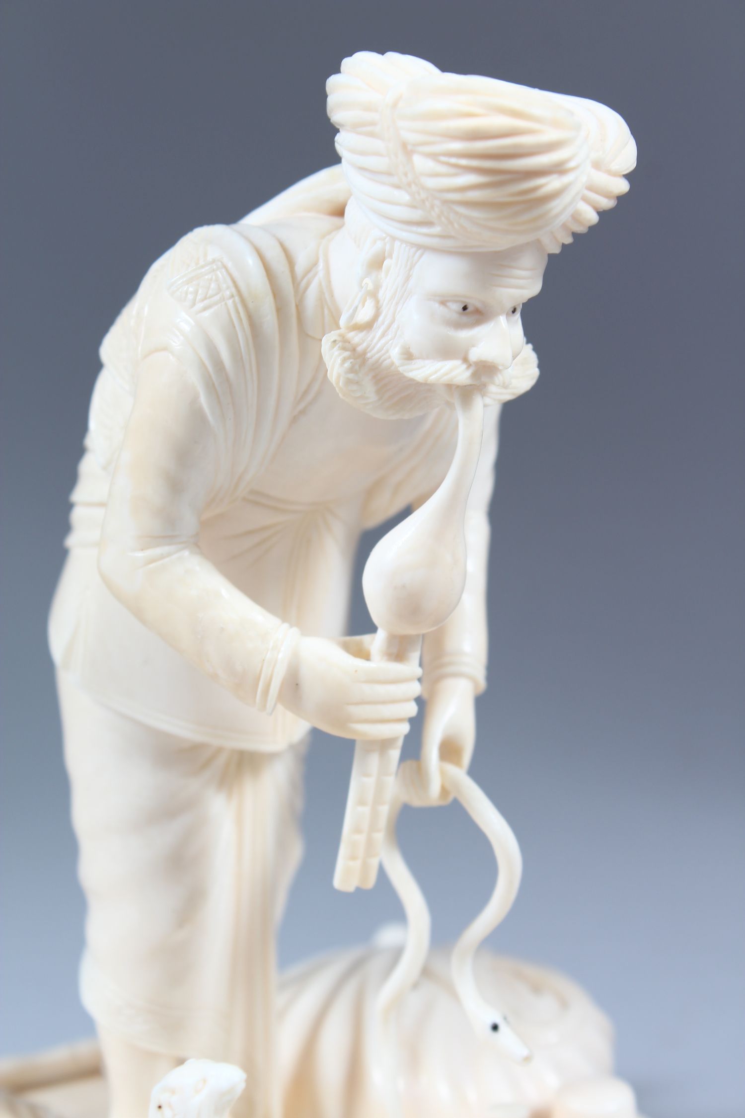 A GOOD 19TH CENTURY INDIAN CARVED IVORY GROUP OF A SNAKE CHARMER with three snakes, standing on a - Image 3 of 7