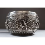 A 19TH CENTURY BURMESE SILVER CIRCULAR BOWL, 14.5cm diameter, the sides repousse with six panels