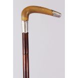 A RHINO HANDLED CANE, carved with a curving handle, silver tip and silver band. 84cm long.