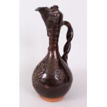 ,A RARE CANAKKALE TURKISH POTTERY POURING VESSEL brown glazed with entwined handle, scrolls and