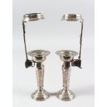 A VERY FINE PAIR OF PERSIAN WHITE METAL CANDLESTICKS, 19cm high with holders.