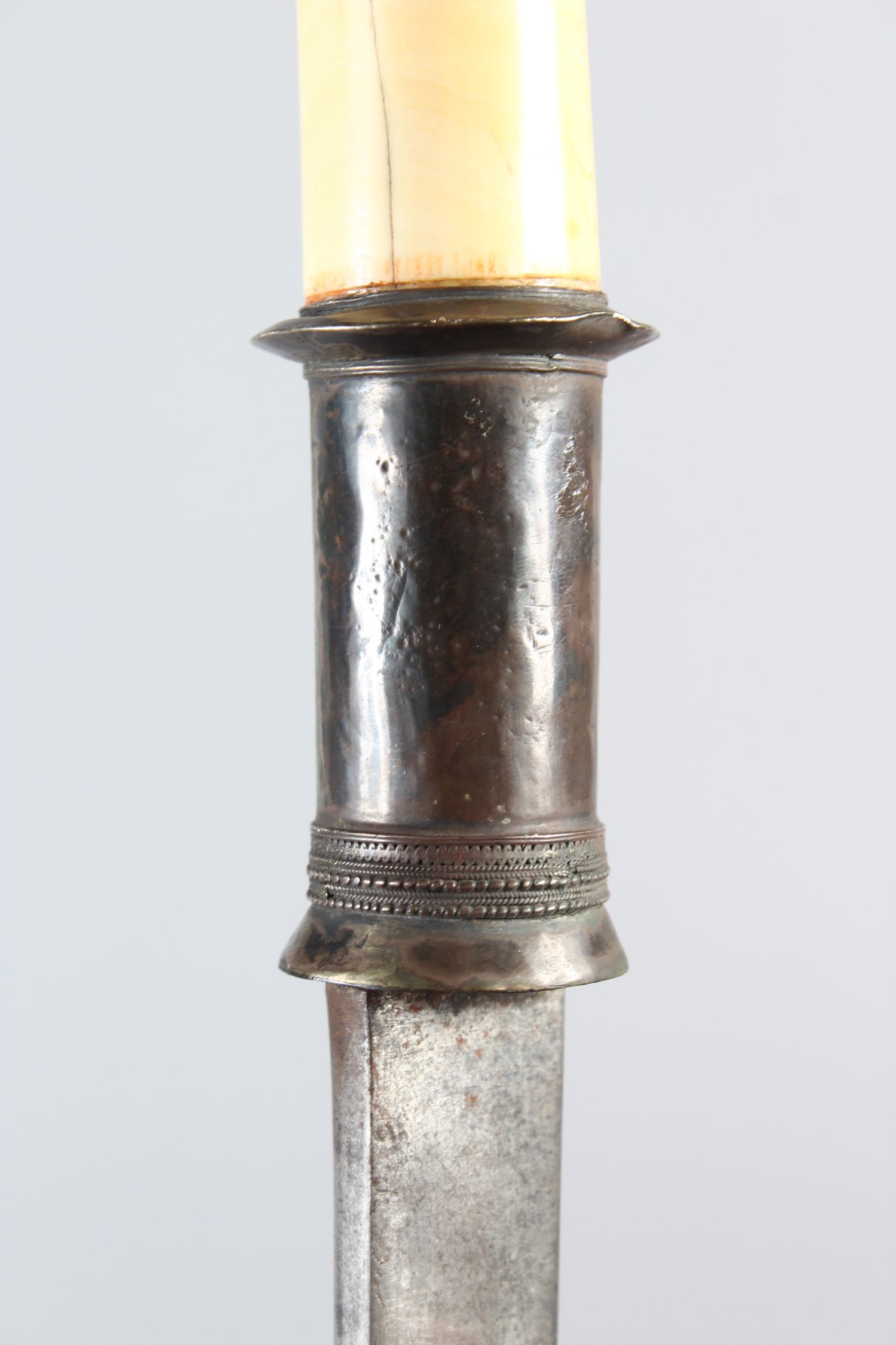 A 19TH CENTURY BURMESE IVORY HILTED SILVER MOUNTED DHA SWORD, with metal scabbard and rope, 84cm - Image 2 of 5