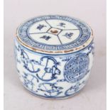 A CHINESE BLUE AND WHITE CIRCULAR INKSTONE, with calligraphy. 9cm diameter.