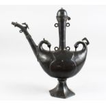 AN INTERESTING INDIAN BRONZE PILGRIM SHAPED EWER with birds head terminal on a octagonal base,