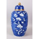 A 19TH CENTUR`Y CHINESE BLUE AND WHITE PRUNUS PATTERN VASE AND COVER, with ormolu finial. 40cm