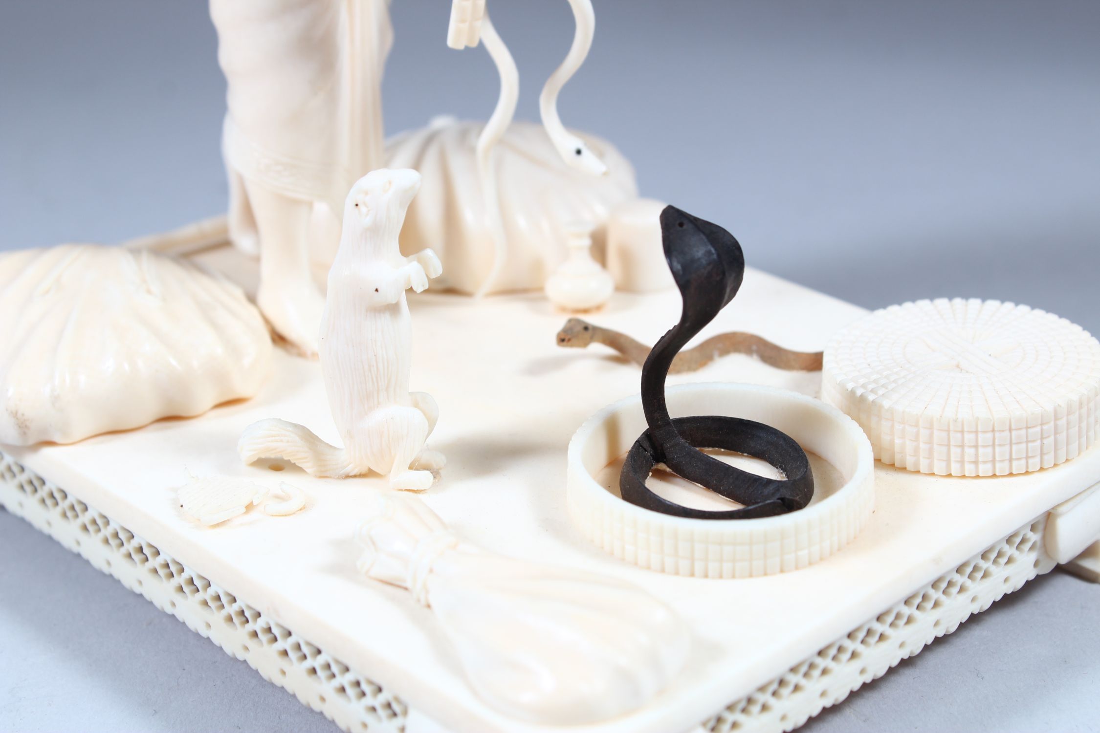 A GOOD 19TH CENTURY INDIAN CARVED IVORY GROUP OF A SNAKE CHARMER with three snakes, standing on a - Image 4 of 7