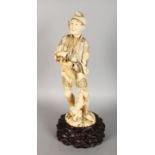 A LARGE JAPANESE MEIJI PERIOD SECTIONAL IVORY FIGURE OF A HUNTER, together with a fitted wood stand,