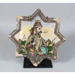 A PERSIAN QAJAR STAR POTTERY TILE, depicting a man resting on his gun, 30cm.