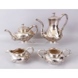 A HONG KONG C.J. CO FOUR PIECE SILVER TEA SET, hammered silver with a dragon in relief, comprising