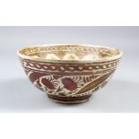 A 17TH CENTURY PERSIAN SAFAVID LUSTRE WARE POTTERY BOWL, the centre decorated with a band of ten