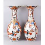 A LARGE PAIR OF JAPANESE IMARI VASES WITH WAVED TOP, the borders painted with panels of carp and