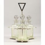 A TANTALUS, with three cut glass decanters. 14ins high.