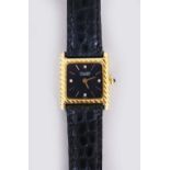 A LADIES VAN CLEEF & ARPELS GOLD WRISTWATCH with leather strap, the face with four diamonds.