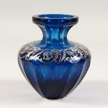 A SILVER OVERLAID BLUE GLASS VASE of squat bulbous form. 6.5ins high.