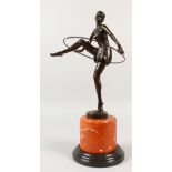 AFTER ALONZO. An Art Deco style bronze of The Hoop Dancer, on a circular marble base. 19ins high.