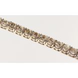 A VERY IMPRESSIVE 18CT WHITE GOLD AND DIAMOND BRACELET comprising thirty six round cut diamonds of
