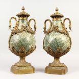 A PAIR OF MARBLE AND ORMOLU URNS, with swan neck handles. 17.5ins high.