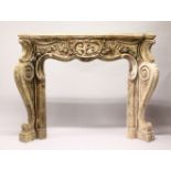A CARVED AND PAINTED WOOD FIRE SURROUND, the mantle carved with cherubs and flowers on bold,