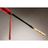 A LADIES' PARASOL, the ivorine handle with studded decoration. 35ins long.