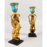 A GOOD PAIR OF FRENCH SEVRES PORCELAIN AND ORMOLU WINGED LION CANDLESTICKS. 9ins high.