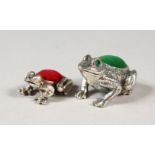 TWO NOVELTY SILVER FROG PIN CUSHIONS.