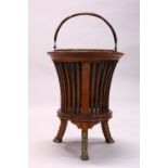 AN EDWARDIAN MAHOGANY JARDINIERE, with brass liner and cast brass paw feet. 1ft 5ins high.