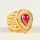 AN 18CT GOLD, DIAMOND AND RUBY PEAR SHAPE RING.