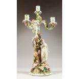 A SITZENDORF CANDELABRA, with three scrolling branches, the base with a young lady and cherub by a
