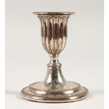 AN OLD SHEFFIELD PLATE DWARF CANDLESTICK, on a circular base. 4.5ins high.