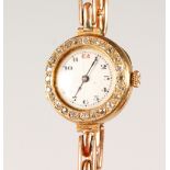 A LADIES' GOLD AND DIAMOND COCKTAIL WATCH.