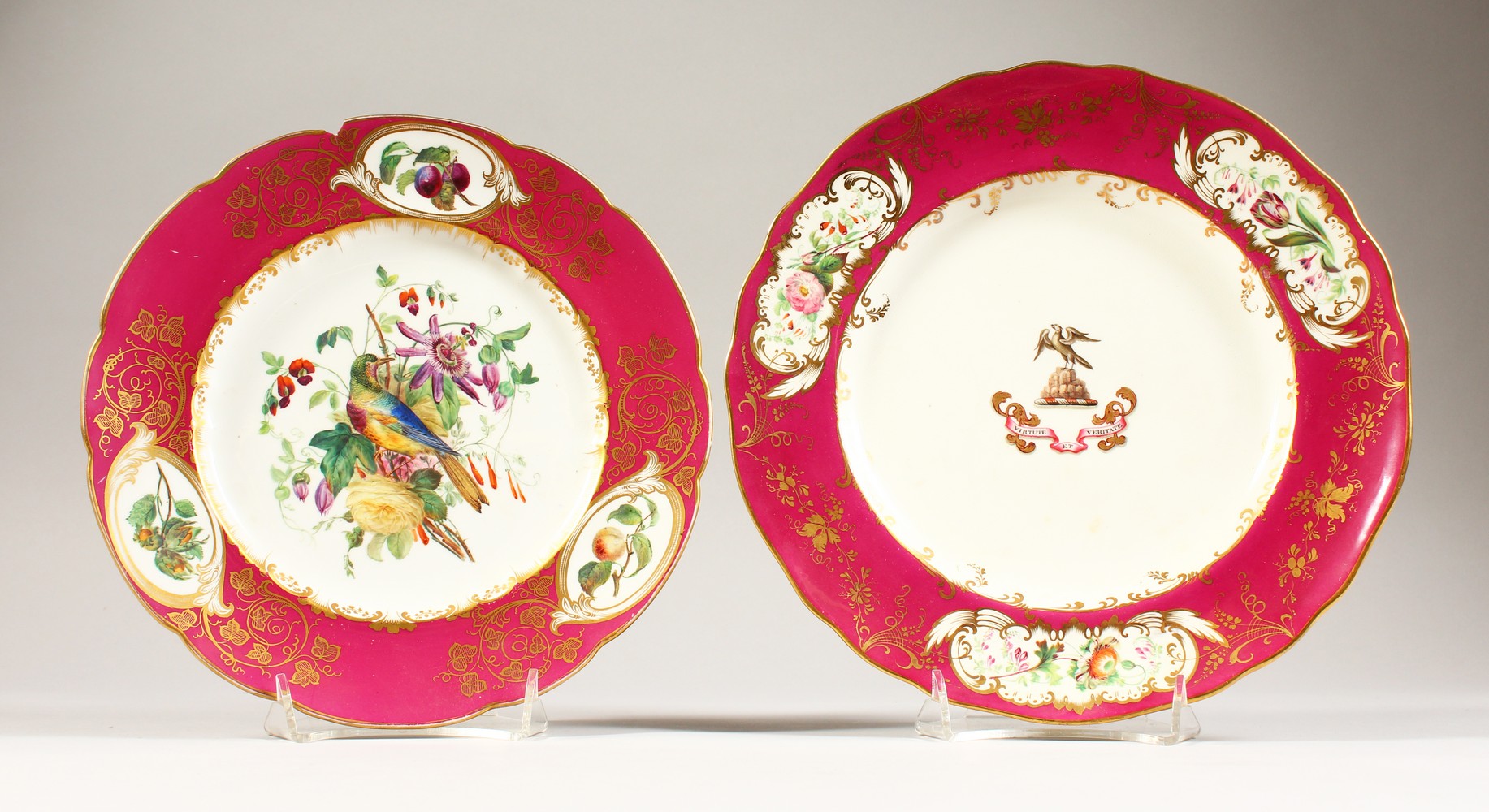 A 19TH CENTURY PORCELAIN ARMORIAL PLATE, with a crest and motto to the centre within a punk ground